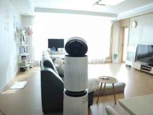 반려견 배변패드가 있는 거실에서 공기청정기가 냄새를 제거하는 모습